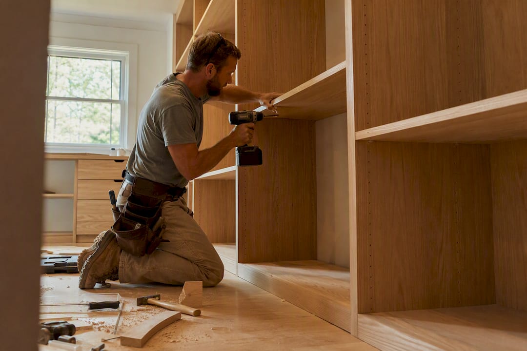 Carpenter installing custom closet drawer