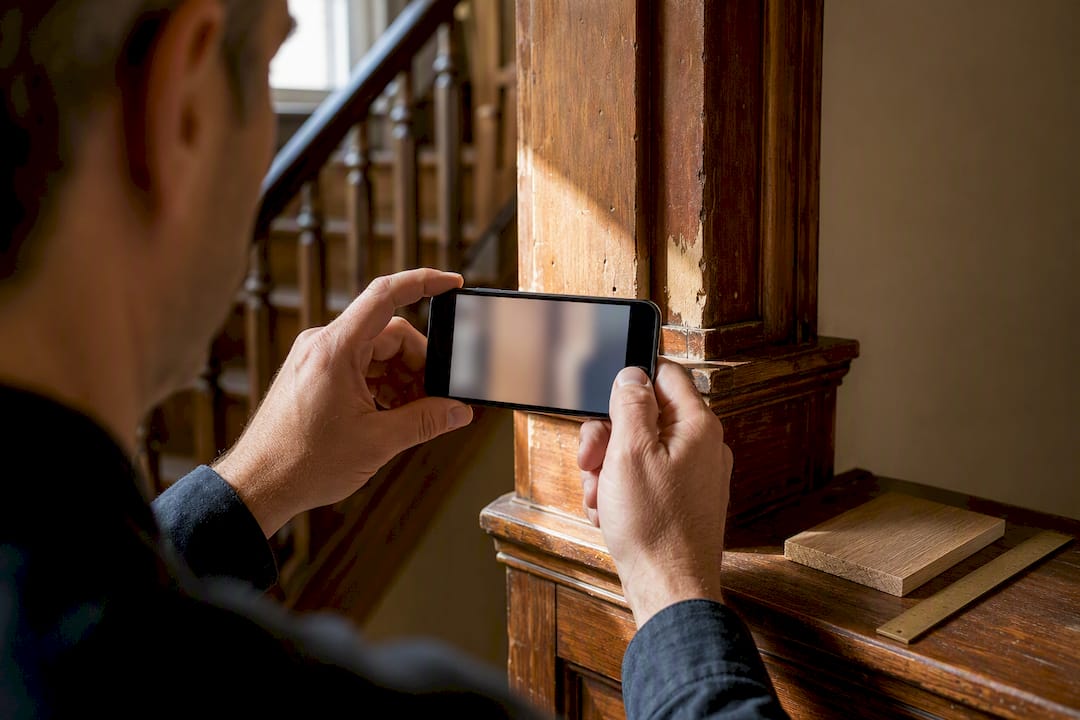 Phone documenting original historic wood trim